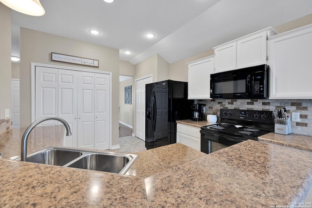 kitchen with white cabinetry, black appliances, tasteful backsplash, and a sink