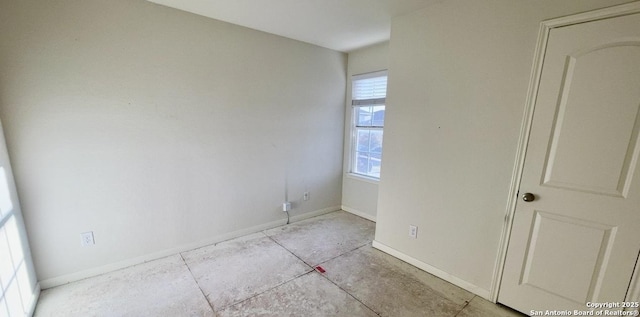 spare room featuring baseboards