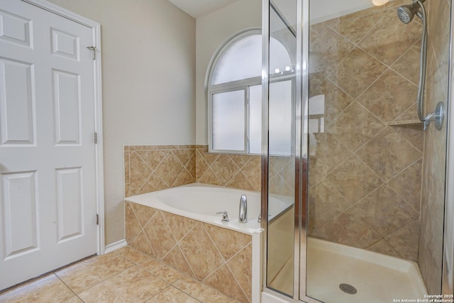 bathroom featuring a garden tub, tile patterned floors, and a shower stall