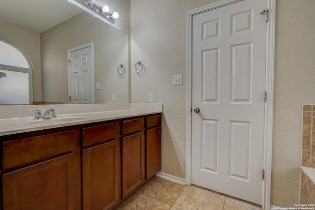 full bathroom featuring tile patterned floors and vanity