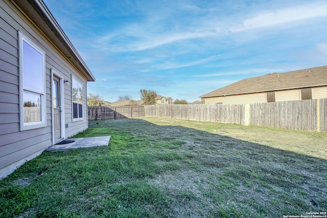 view of yard with a fenced backyard