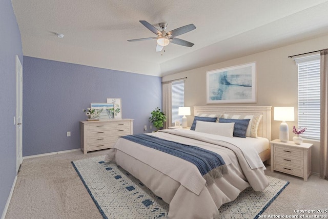 bedroom featuring baseboards, multiple windows, and ceiling fan