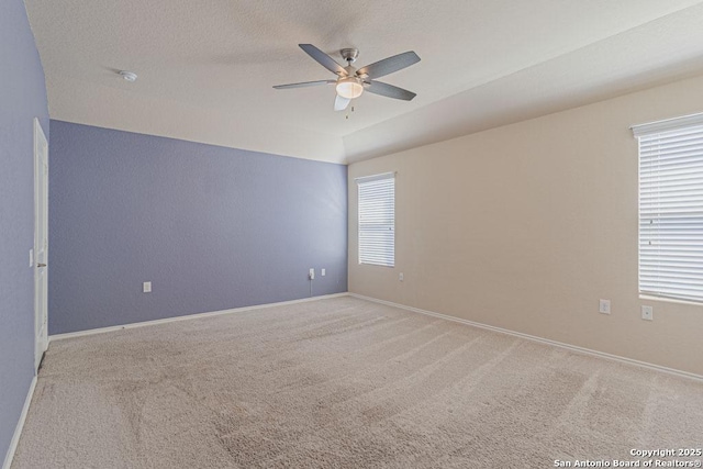 unfurnished room featuring carpet flooring, a textured ceiling, baseboards, and ceiling fan