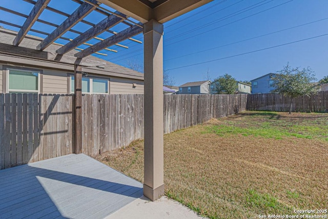 view of yard featuring a wooden deck, a pergola, and a fenced backyard