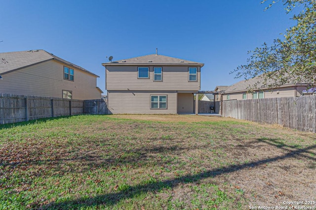 rear view of property featuring a lawn, a fenced backyard, and a pergola