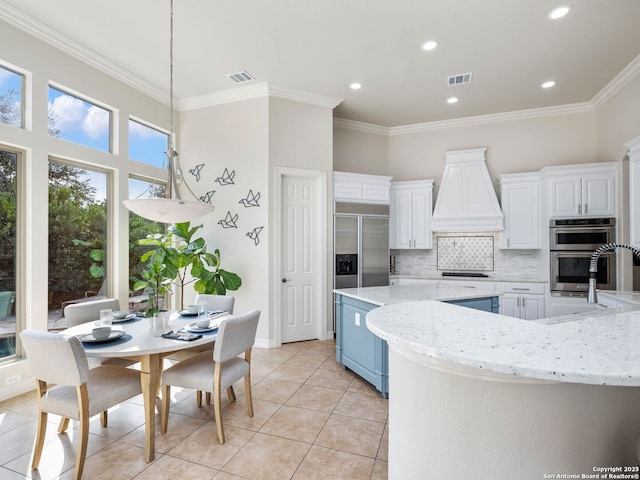 kitchen with tasteful backsplash, visible vents, appliances with stainless steel finishes, and ornamental molding