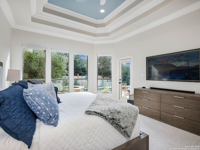 bedroom featuring a raised ceiling, ornamental molding, carpet flooring, and access to outside