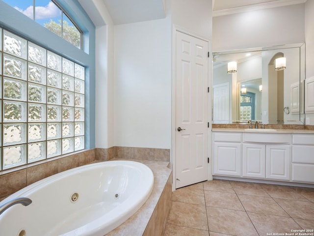 bathroom with tile patterned floors, vanity, and a whirlpool tub