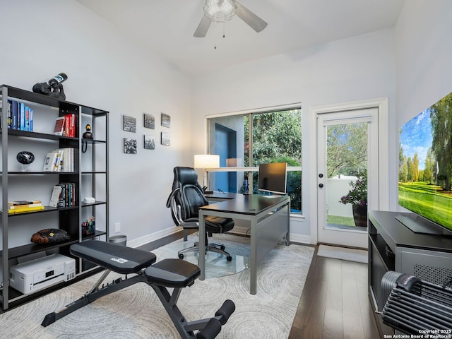 office featuring wood finished floors, baseboards, and ceiling fan