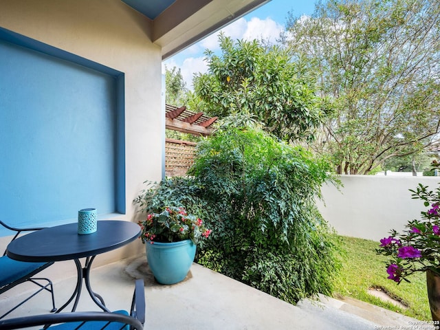 view of patio with a pergola and fence