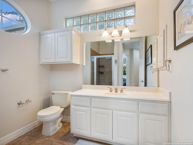 bathroom featuring toilet, a stall shower, tile patterned flooring, baseboards, and vanity