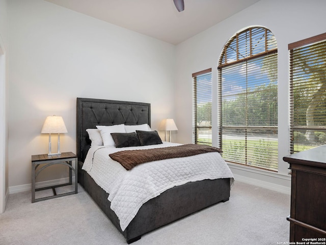 carpeted bedroom with baseboards and ceiling fan