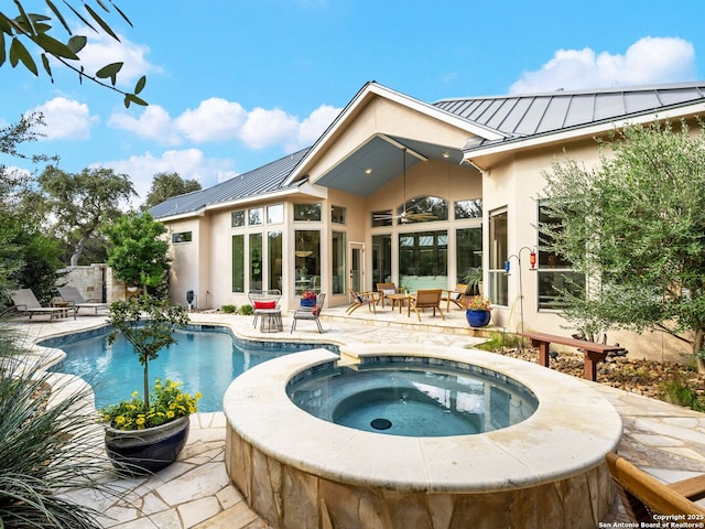 outdoor pool featuring a patio and an in ground hot tub