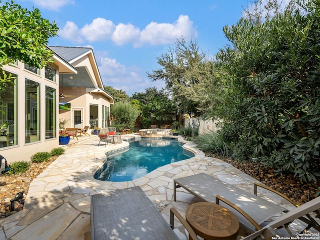 view of pool featuring a patio, fence, a fenced in pool, and an in ground hot tub