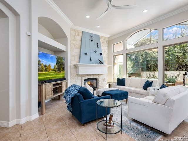 living room with recessed lighting, a stone fireplace, ornamental molding, and light tile patterned flooring