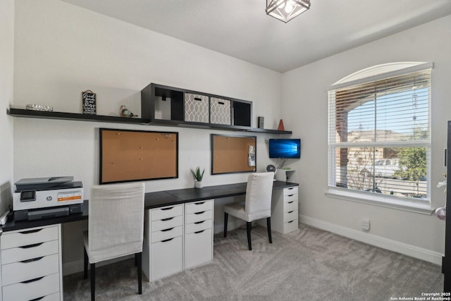 office area with baseboards and light carpet