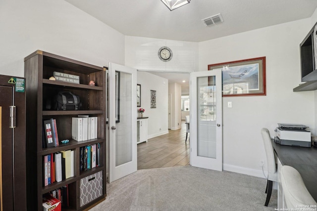 office featuring french doors, visible vents, and carpet flooring