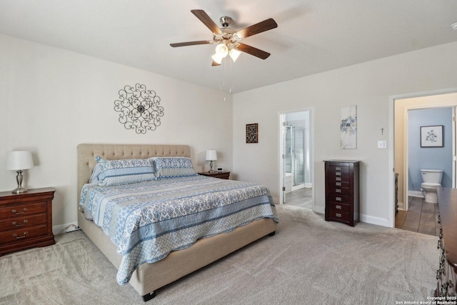 bedroom featuring connected bathroom, baseboards, carpet, and a ceiling fan