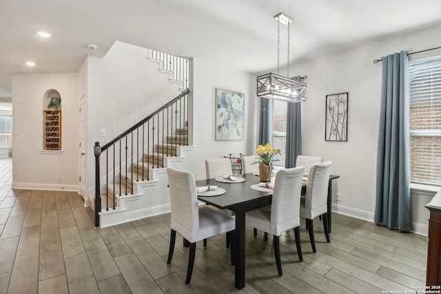 dining space featuring stairway, recessed lighting, baseboards, and wood finished floors