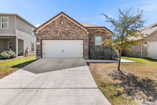 view of front of house with brick siding, an attached garage, driveway, and a front yard