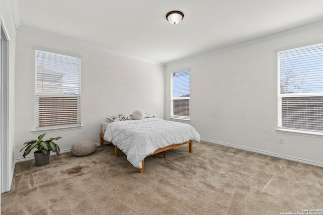 carpeted bedroom featuring baseboards, multiple windows, and crown molding