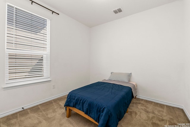 bedroom with visible vents, baseboards, and carpet floors