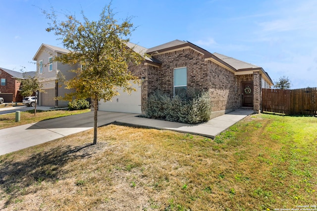 view of front of house with fence, concrete driveway, a front yard, a garage, and brick siding