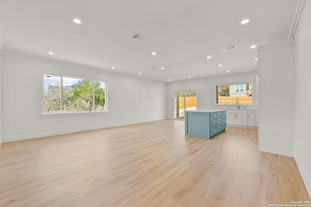 unfurnished living room with recessed lighting, visible vents, baseboards, and light wood finished floors