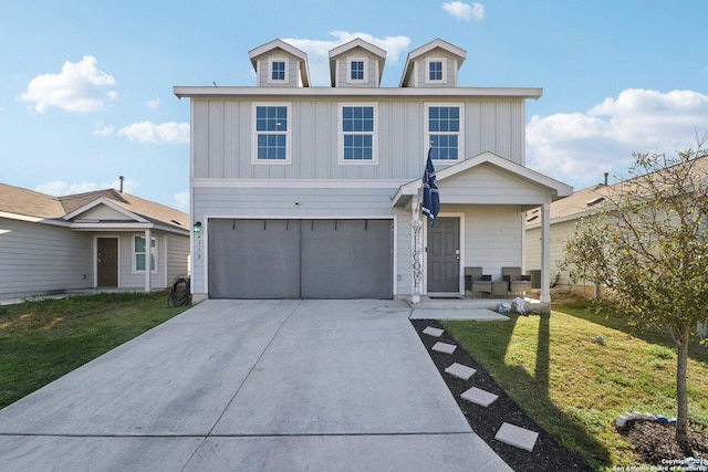 view of front of home with driveway, an attached garage, board and batten siding, and a front yard