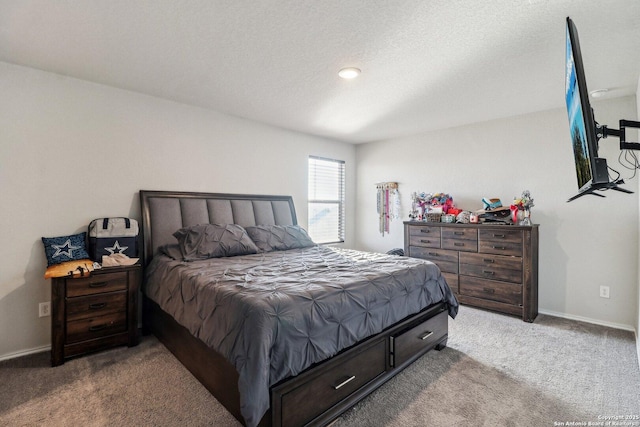 carpeted bedroom featuring baseboards and a textured ceiling