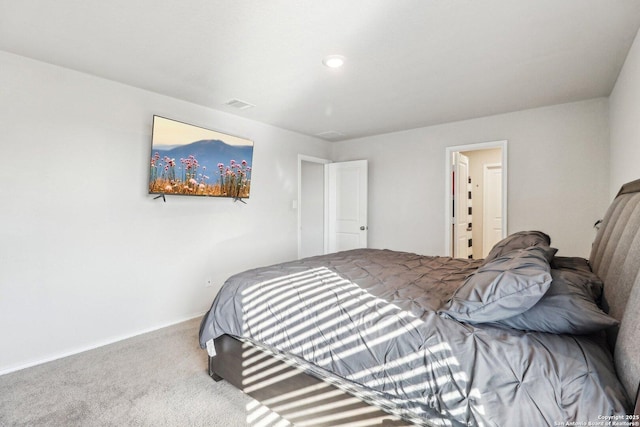 carpeted bedroom with visible vents and baseboards