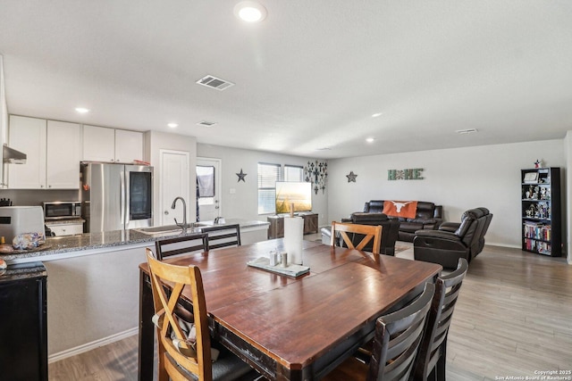 dining space featuring recessed lighting, visible vents, and light wood-style floors