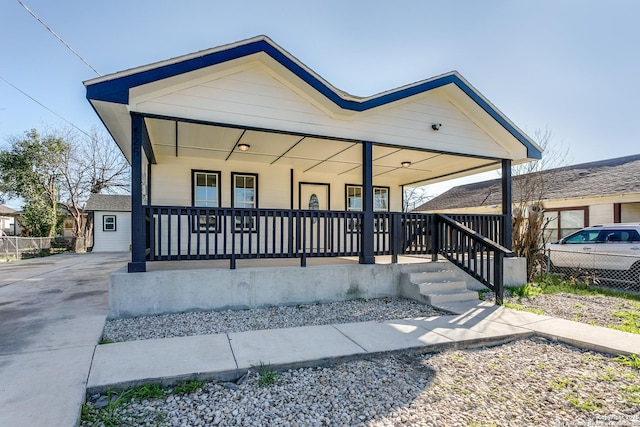 view of front of house featuring a porch and fence