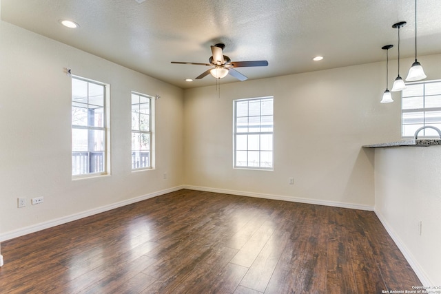 interior space with ceiling fan, baseboards, dark wood finished floors, recessed lighting, and a sink