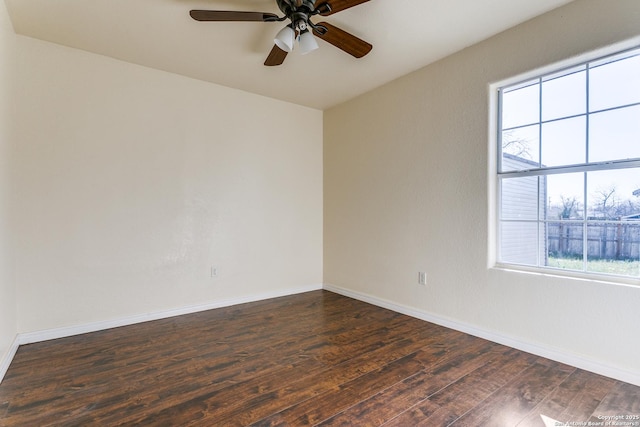 unfurnished room featuring dark wood finished floors, ceiling fan, and baseboards