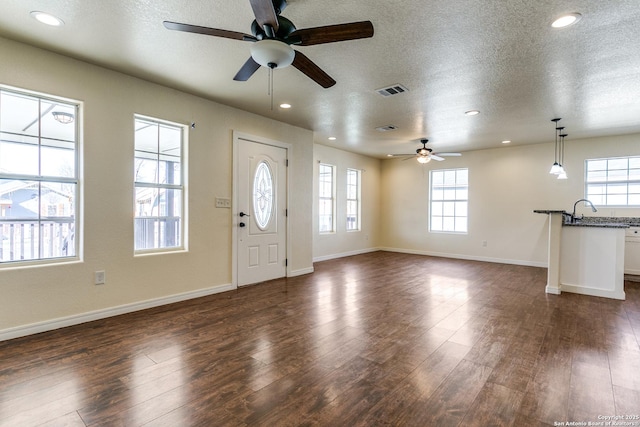 entrance foyer with visible vents, dark wood-type flooring, a textured ceiling, recessed lighting, and baseboards