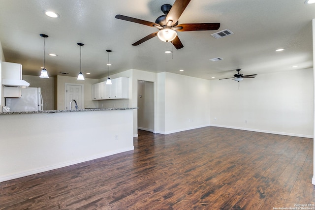 unfurnished living room featuring visible vents, baseboards, dark wood finished floors, recessed lighting, and a ceiling fan