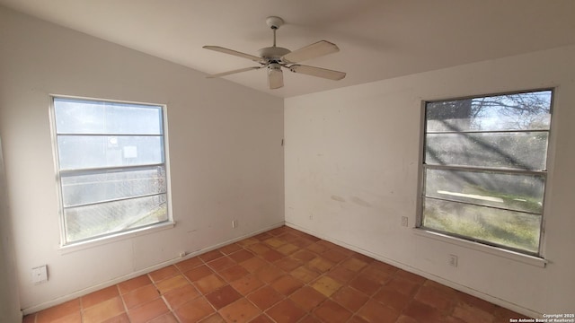 spare room featuring lofted ceiling and ceiling fan