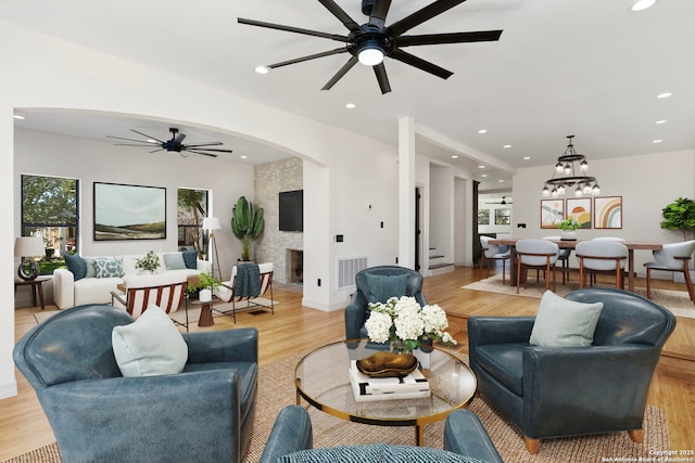 living room with visible vents, light wood-style flooring, a ceiling fan, recessed lighting, and a large fireplace