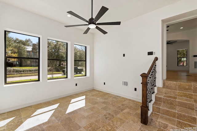 spare room with visible vents, baseboards, recessed lighting, stone finish floor, and a ceiling fan