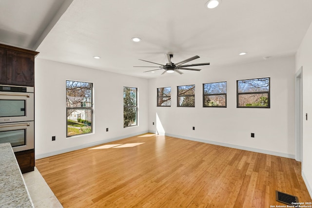 unfurnished living room with visible vents, recessed lighting, and light wood-style floors