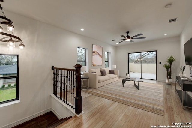 living area featuring visible vents, recessed lighting, baseboards, and wood finished floors