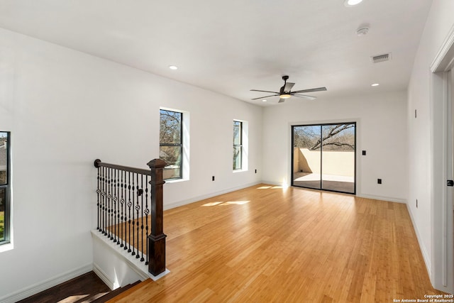 spare room featuring baseboards, visible vents, and light wood finished floors