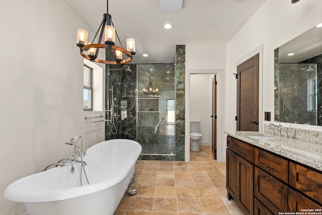 full bath featuring a shower stall, a freestanding bath, toilet, a notable chandelier, and vanity