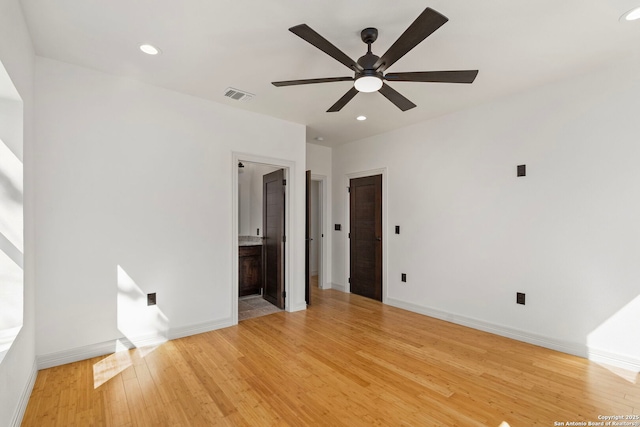 interior space with visible vents, connected bathroom, baseboards, recessed lighting, and light wood-style flooring