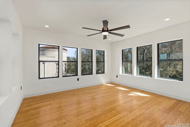 empty room with baseboards and light wood-style floors