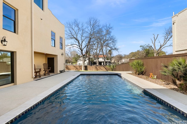 view of swimming pool with a patio, a fenced backyard, and a fenced in pool