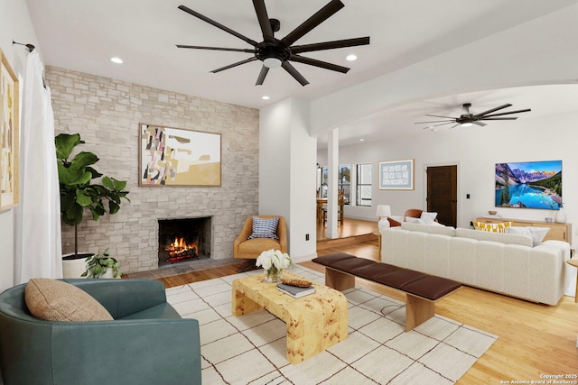 living room with a fireplace, recessed lighting, wood finished floors, and ceiling fan