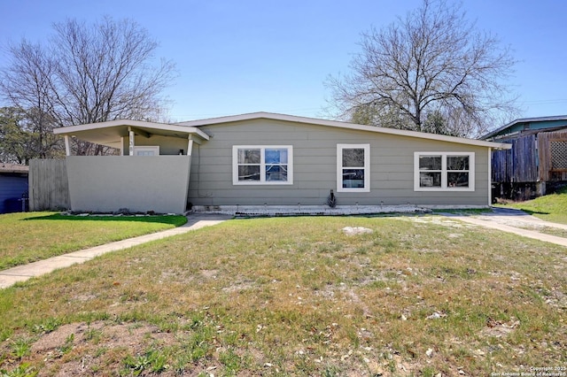 view of front of home with a front yard and fence