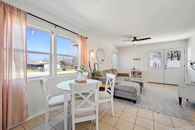 dining space featuring a ceiling fan, light tile patterned floors, and french doors